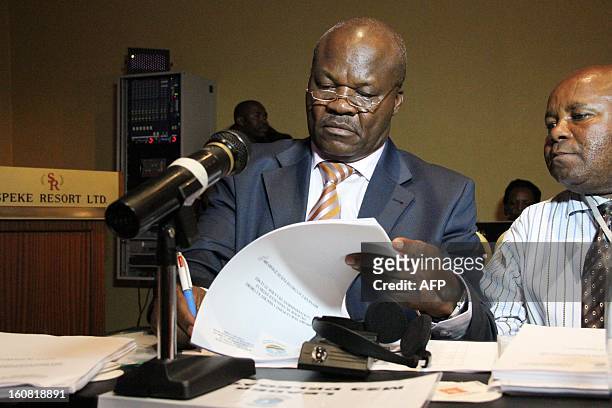 The head of the M23 Congolese rebels, Roger Lumbala, signs documents on February 6, 2013 before a press briefing in Kampala. The government of the...