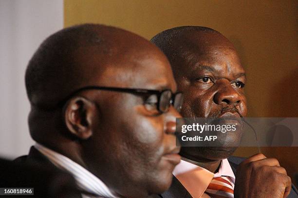 Ugandan Defense Minister Crispus Kiyonga and the head of the M23 Congolese rebels, Roger Lumbala, signs documents on February 6, 2013 before a press...