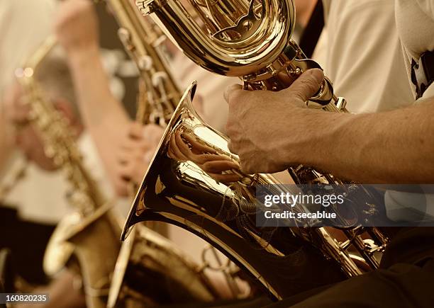 saxaphone player - brass band stock pictures, royalty-free photos & images