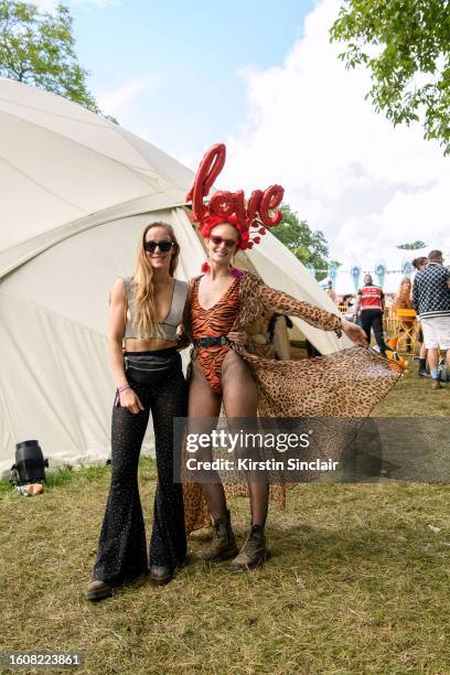 Hum Fleming wears a diamante bra top, sheer black trousers with diamante embellishment, black belt bag, black sunglasses and lace up boots with Chloe...