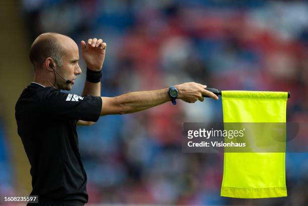 The assistant referee holds his flag up for an offside during the pre-season friendly match between Crystal Palace and Olympique Lyonnais at Selhurst...