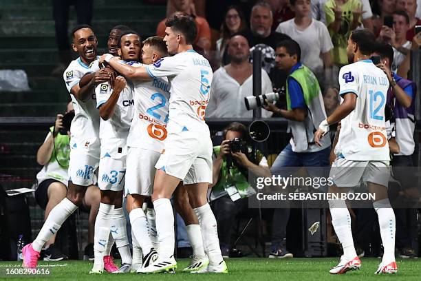 Marseille's French midfielder Emran Soglo celebrates with teammates after scoring the first goal for his team during the French L1 football match...