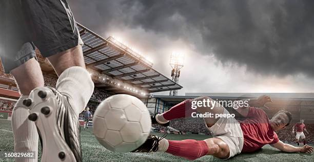 calciatore a sliding tackle??? - placcare foto e immagini stock