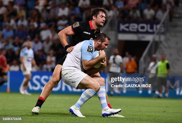 Bayonne's french fly-half Camille Lopez grabs the ball during the French Top 14 rugby union match between Aviron Bayonnais and Stade Toulousain at...