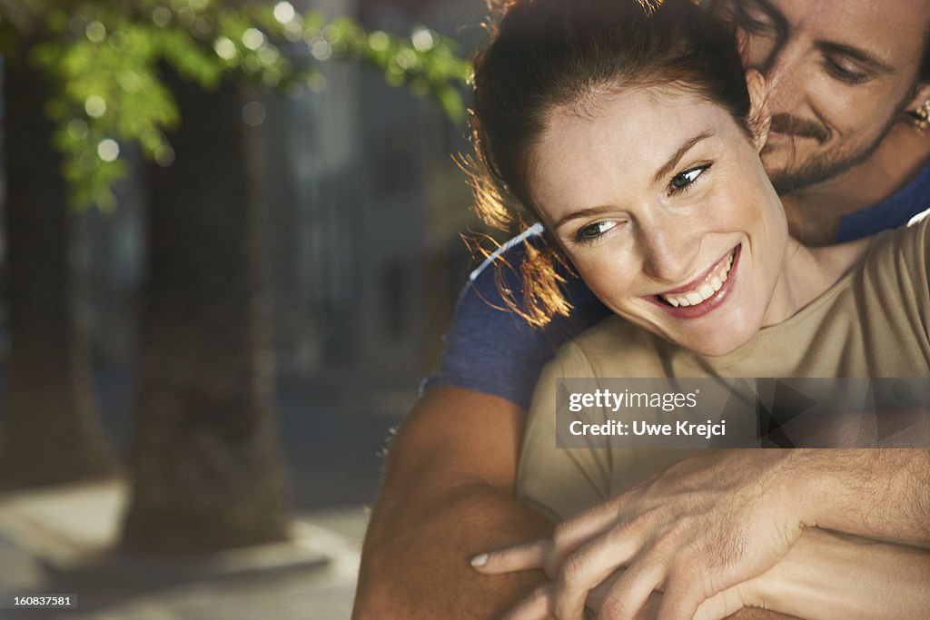 Couple embracing, smiling