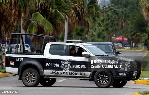 Graphic content / A Municipal Police vehicle patrols in Lagos de Moreno, Jalisco State, Mexico, on August 18 following the disappearance of five...