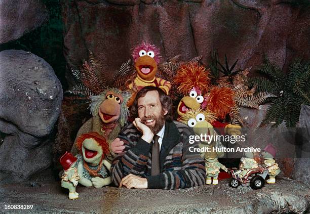 American puppeteer and filmmaker Jim Henson with some of the Muppet cast from the children's TV show 'Fraggle Rock', circa 1985. Along with the...