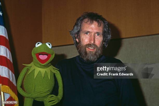 American puppeteer and filmmaker Jim Henson with his best-known Muppet character, Kermit the Frog, January 1984.