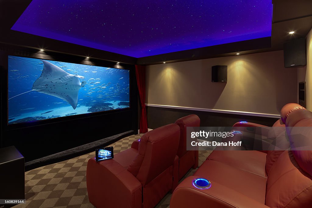A movie plays on a high end luxury home theater sy