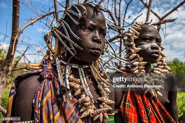 Young boys of the tribe Mursi with necklaces of shells in head. The Mursi tribe They are nomadic cattle herders live in the lower Omo Valley inside...