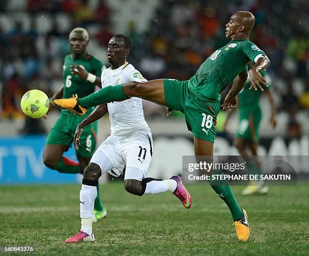 Burkina Faso's midfielder Charles Kabore vies with Ghana's midfielder Mohammed Rabiu during the 2013 African Cup of Nations semi-final football match...