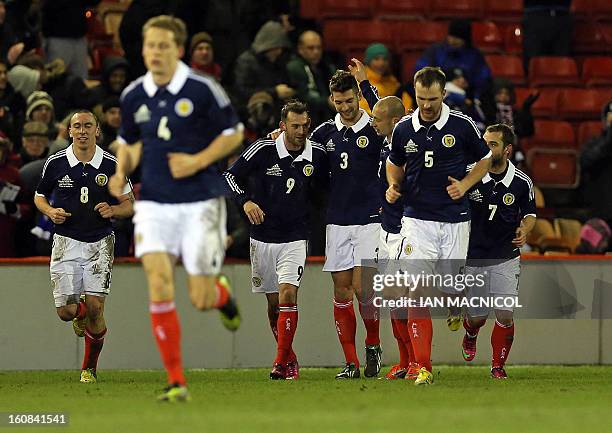 Teammates, defender Alan Hutton and striker Steven Fletcher congratulate Charlie Mulgrew after he scores the opening goal of the international...