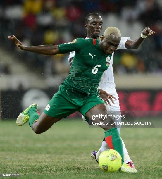 Burkina Faso's midfielder Djakaridja Kone vies with Ghana's midfielder Mohammed Rabiu during the 2013 African Cup of Nations semi-final football...