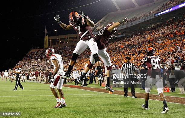 Receiver Corey Fuller of the Virginia Tech Hokies celebrates his touchdown catch with Marcus Davis during the Russell Athletic Bowl Game against the...
