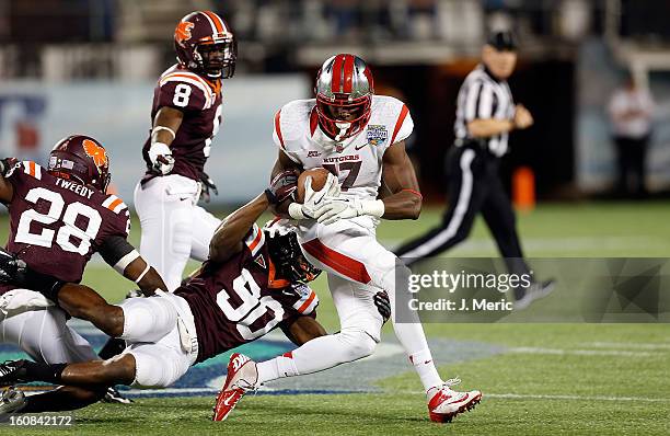 Defensive end Dadi Nicolas of the Virginia Tech Hokies tackles receiver Brandon Coleman of the Rutgers Scarlet Knights during the Russell Athletic...