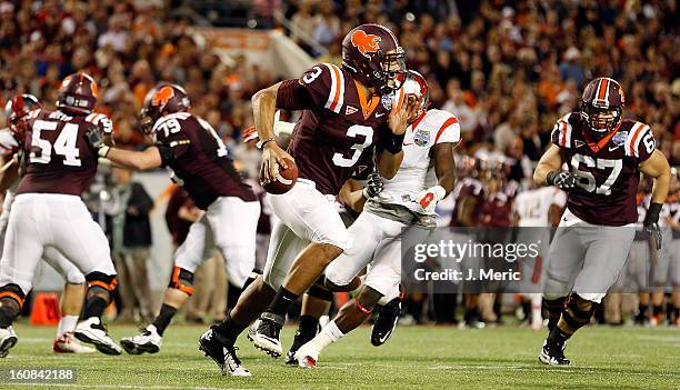 Quarterback Logan Thomas of the Virginia Tech Hokies scrambles against the Rutgers Scarlet Knights during the Russell Athletic Bowl Game at the...