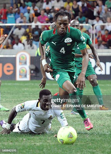 Burkina Faso's defender Bakary Kone runs with the ball past Ghana's midfielder Christian Atsu during the 2013 African Cup of Nations semi-final...