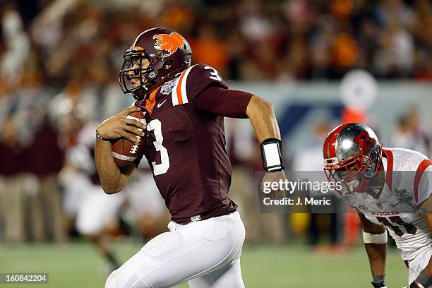 Quarterback Logan Thomas of the Virginia Tech Hokies scrambles against the Rutgers Scarlet Knights during the Russell Athletic Bowl Game at the...