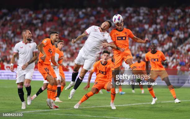 Lucas Ocampos of Sevilla and Hugo Duro of Valencia battle for a header during the LaLiga EA Sports match between Sevilla FC and Valencia CF at on...