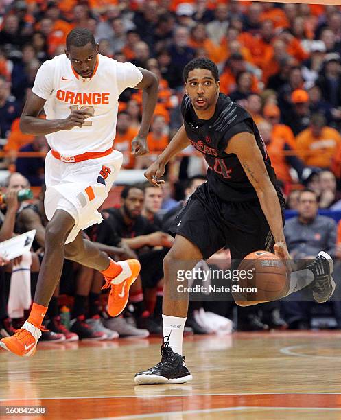 Jaquon Parker of the Cincinnati Bearcats drives to the basket as he is followed by Baye Mousa Keita of the Syracuse Orange during the game at the...