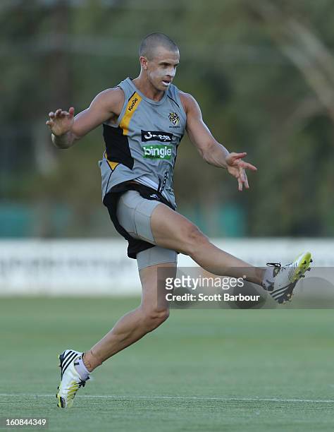 Brett Deledio of the Tigers kicks the ball during a Richmond Tigers AFL training session ahead of the AFL exhibition match between the Richmond...