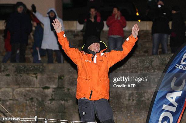 Britain's skipper Mike Golding celebrates on his monohull "Gamesa" as he finished sixth of the 7th edition of the Vendee Globe solo round-the-world...