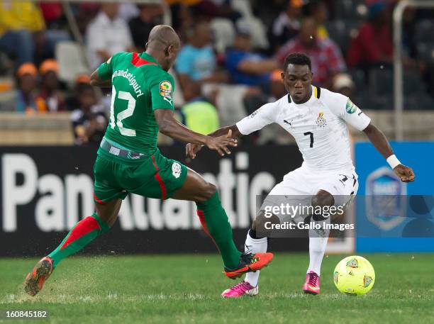 Christian Atsu Twasam from Ghana and Saidou Mady Panandetiguiri from Burkina Faso compete for the ball during the 2013 Orange African Cup of Nations...