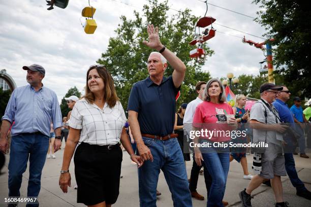 Former U.S. Vice President and current presidential candidate Mike Pence and his wife Karen Pence and Sen. Joni Ernst tour the Iowa State Fair on...