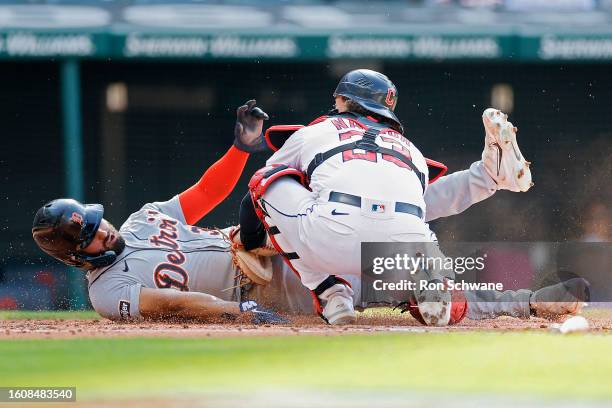 Catcher Bo Naylor of the Cleveland Guardians tags out a sliding Riley Greene of the Detroit Tigers attempting to score during the third inning of...