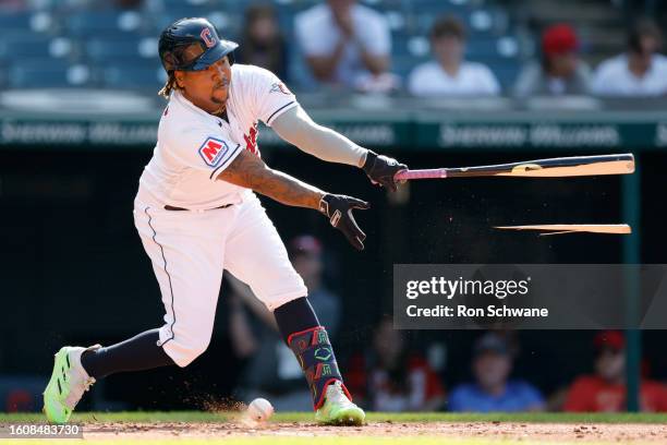 Jose Ramirez of the Cleveland Guardians breaks his bat on a foul ball against the Detroit Tigers during the third inning of game one of a...