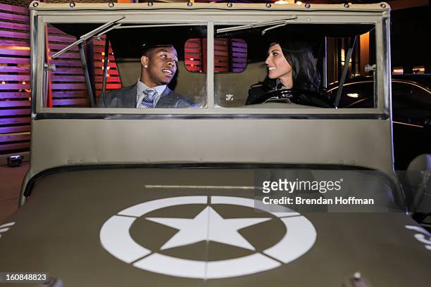 Superbowl champion Baltimore Raven Ray Rice and actress Olivia Munn sit in a 1941 Willys MB at the launch event for Jeep Operation Safe Return at the...