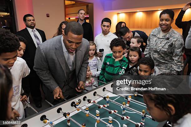 Superbowl champion Baltimore Raven Ray Rice plays foosball with military members and their families at the launch event for Jeep Operation Safe...