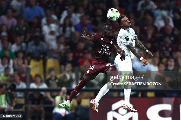 Metz's Senegalese midfielder Cheikh Tidiane Sabaly fights for the ball with Marseille's French defender Jonathan Clauss during the French L1 football...