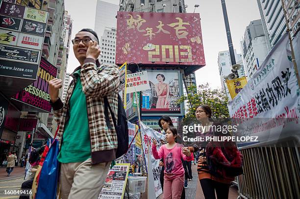 Lifestyle-Asia-offbeat-Lunar, FEATURE by Beh Lih Yi Pedestrians walk past a billboard set up for the Chinese New Year of the snake in Hong Kong on...