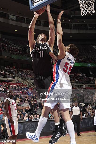 Brook Lopez of the Brooklyn Nets shoots against Viacheslav Kravtsov of the Detroit Pistons on February 6, 2013 at The Palace of Auburn Hills in...