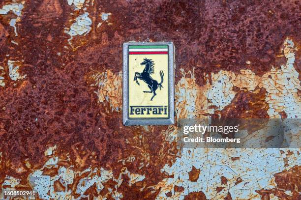 Ferrari badge on a derelict vehicle from the 'Lost & Found Collection' during the RM Sotheby's auto auction at the 2023 Pebble Beach Concours...