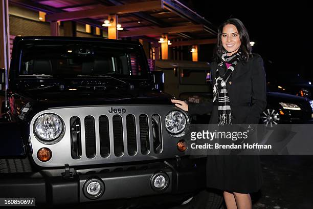 Actress Olivia Munn poses for a picture with the Jeep Wrangler Freedom Edition at the launch event for Jeep Operation Safe Return at the USO Warrior...