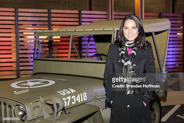 Actress Olivia Munn poses in front of a 1941 Willys MB at the launch event for Jeep Operation Safe Return at the USO Warrior & Family Center on...