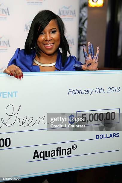 Designer Carmen Green of Baltimore, MD poses with her prize check after winning The Aquafina "Pure Challenge" at the Aquafina "Pure Challenge" After...