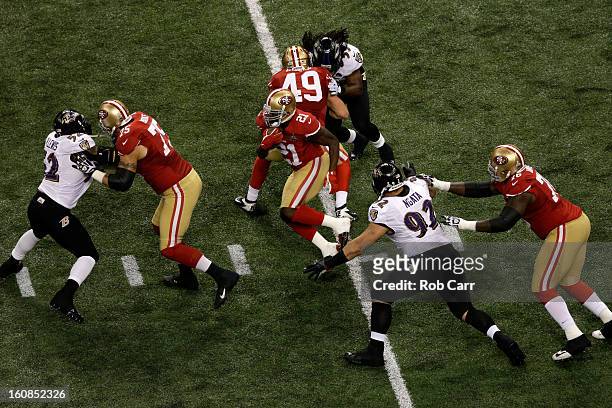 Frank Gore of the San Francisco 49ers runs the ball against Haloti Ngata of the Baltimore Ravens during Super Bowl XLVII at the Mercedes-Benz...