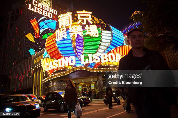 Pedestrians cross an intersection in front of the Casino Lisboa, operated by SJM Holdings Ltd., in Macau, China, on Wednesday, Feb. 6, 2013. Casino...