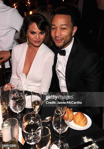 Christine Teigen and John Legend attend the amfAR New York Gala to kick off Fall 2013 Fashion Week at Cipriani Wall Street on February 6, 2013 in New...