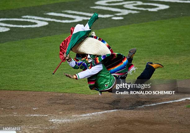 Fan dives into home plate after running out onto the field of Sonora Stadium during a match between Yaquis de Obregon of Mexico and Criollos de...
