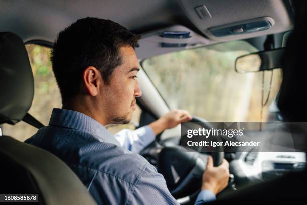 driver attentive to right turn - real people stockfoto's en -beelden