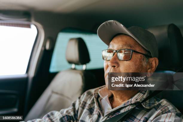 portrait of an elderly man driving - travel real people stockfoto's en -beelden