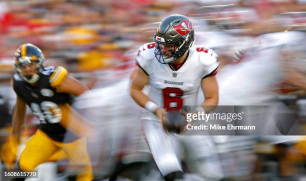 Baker Mayfield of the Tampa Bay Buccaneers hands off during a preseason game against the Pittsburgh Steelers at Raymond James Stadium on August 11,...