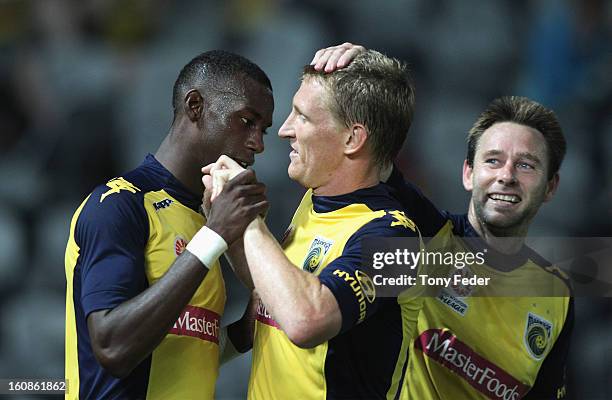 Bernie Ibini of the Mariners celebrates with team mates Daniel McBreen and Joshua Rose, after scoring a second goal during the round 20 A-League...