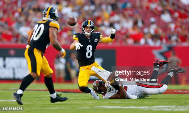 Kenny Pickett of the Pittsburgh Steelers escapes a tackle from Mike Greene of the Tampa Bay Buccaneers during a preseason game at Raymond James...