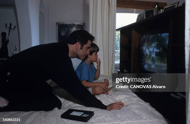 Rendezvous With John Travolta. Juillet 1996- Portrait de John TRAVOLTA et de sa famille chez lui. John TRAVOLTA regardant la télévision avec son fils...