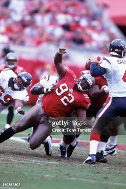 Defensive lineman Warren Sapp of the Tampa Bay Buccaneers tries to get to the quarterback during a game on December 14, 2003 against the Houston...